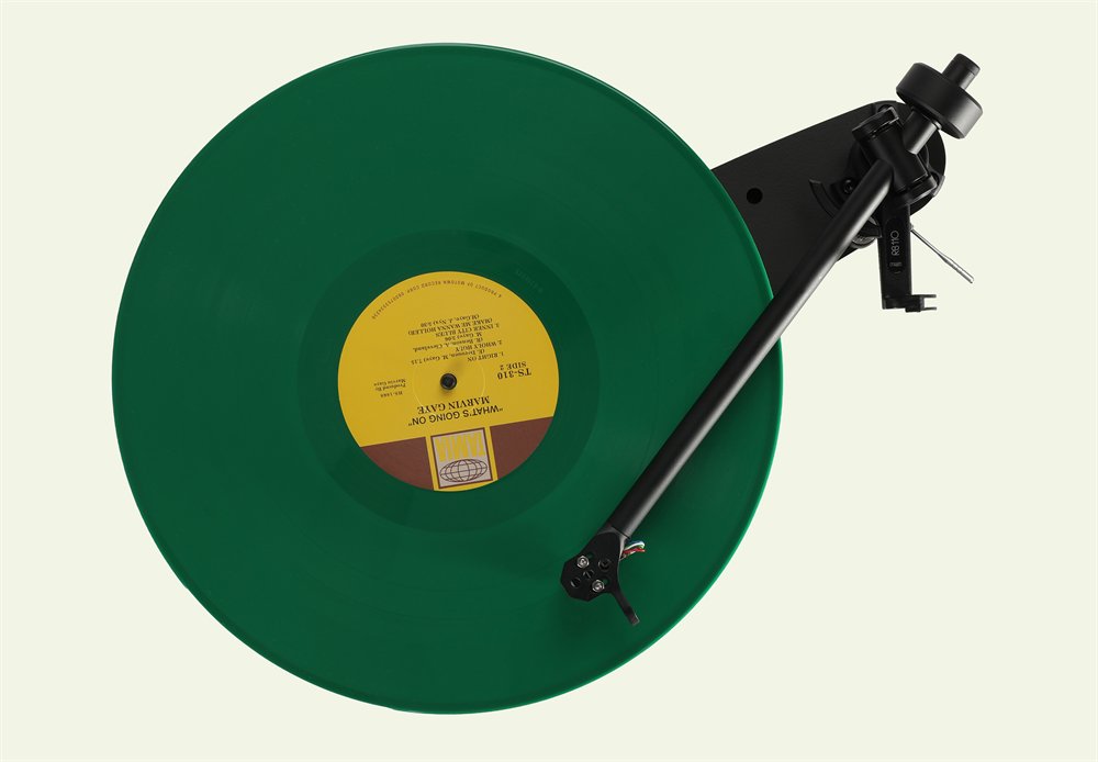 The Rega Replay in matt black seen from directly above, a green record on the platter and the RB110 tonearm resting beside it.